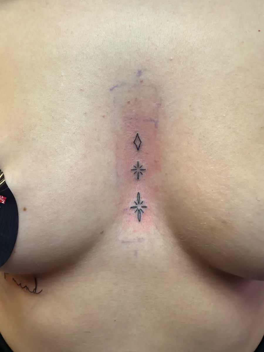 Fine line floral tattoo on the sternum, Phantom Avenue Edmonton