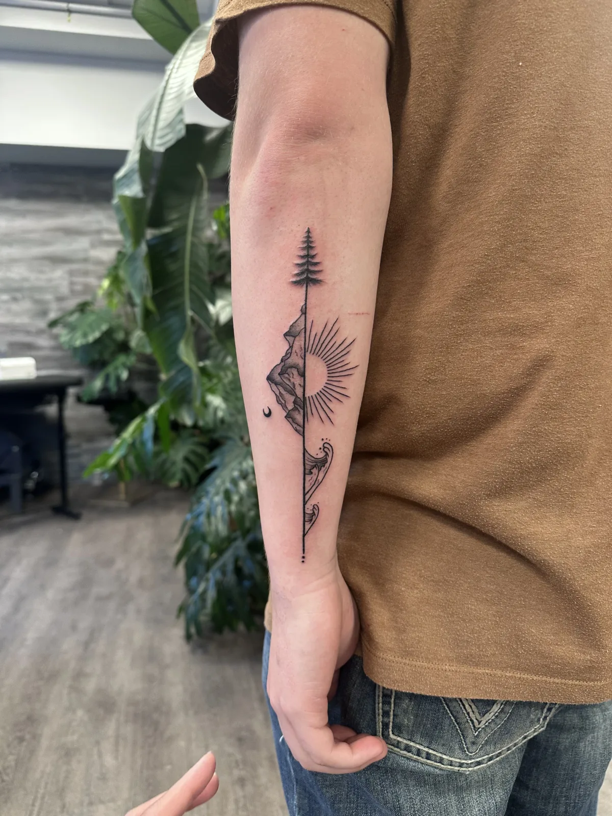 Floral tattoo with an arrow on the inner forearm, Phantom Avenue Edmonton