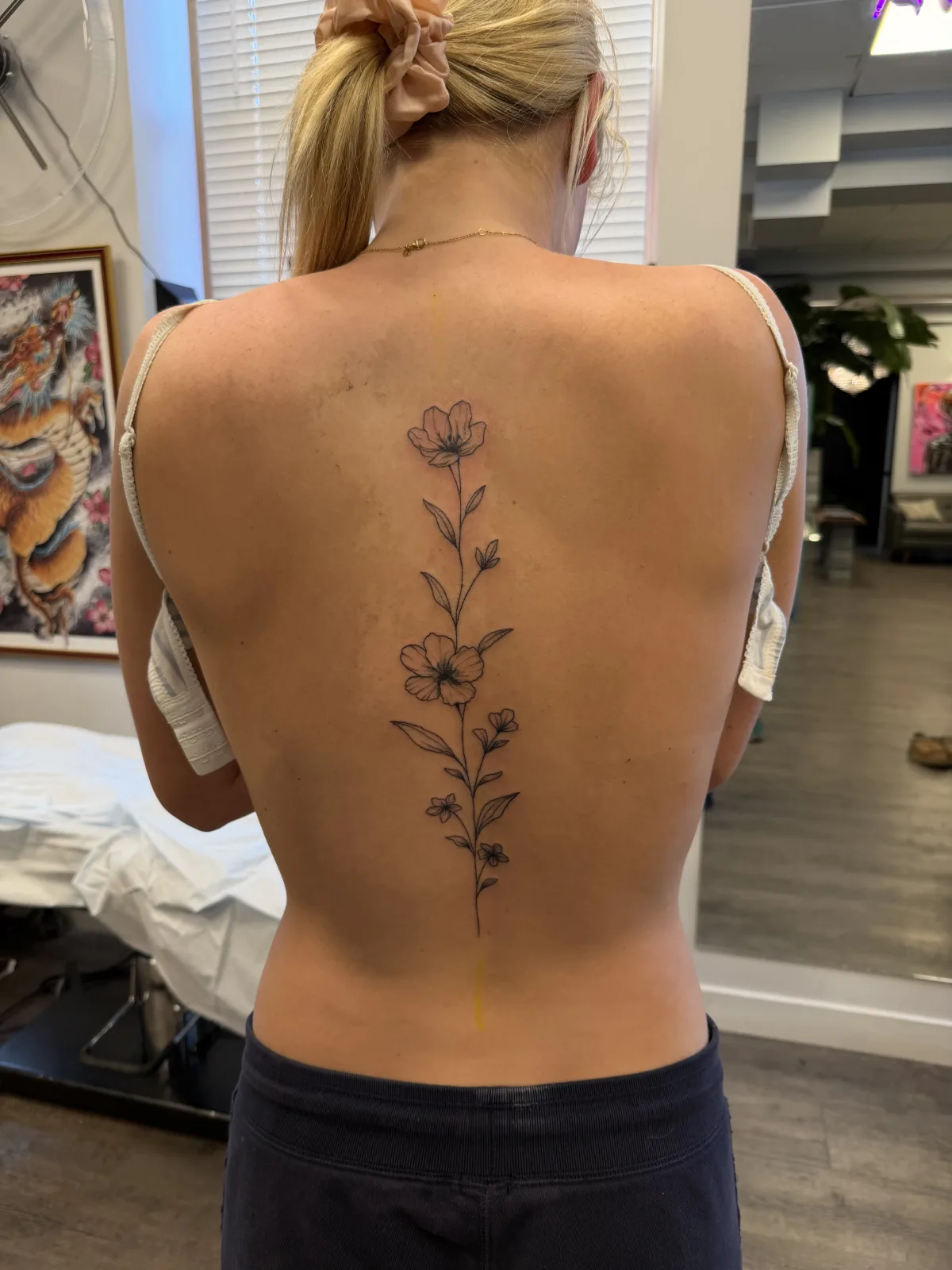 Fine line floral tattoo down the spine, Phantom Avenue Edmonton